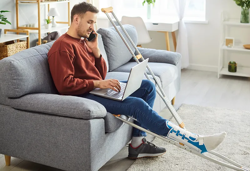 Injured person researching injury lawyers on laptop